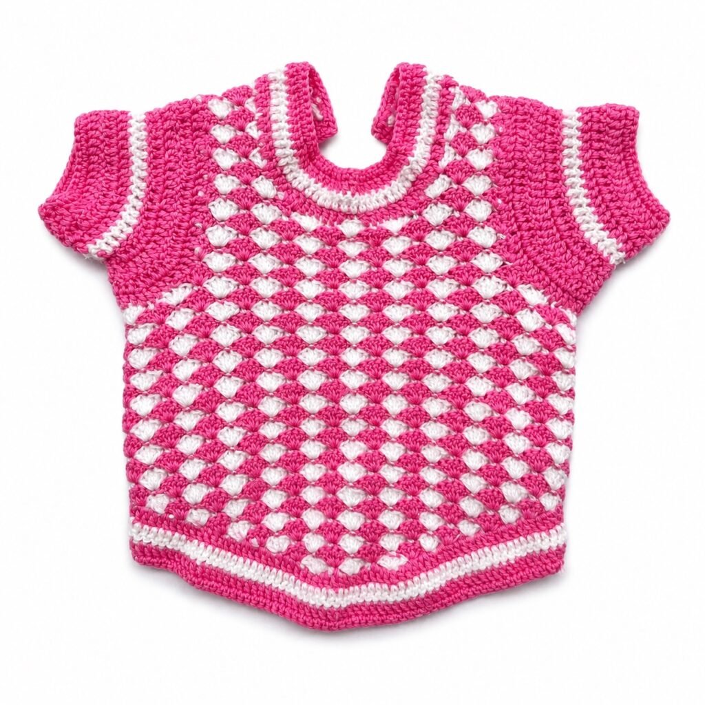 Pink and white crochet pattern on the back of the sweater